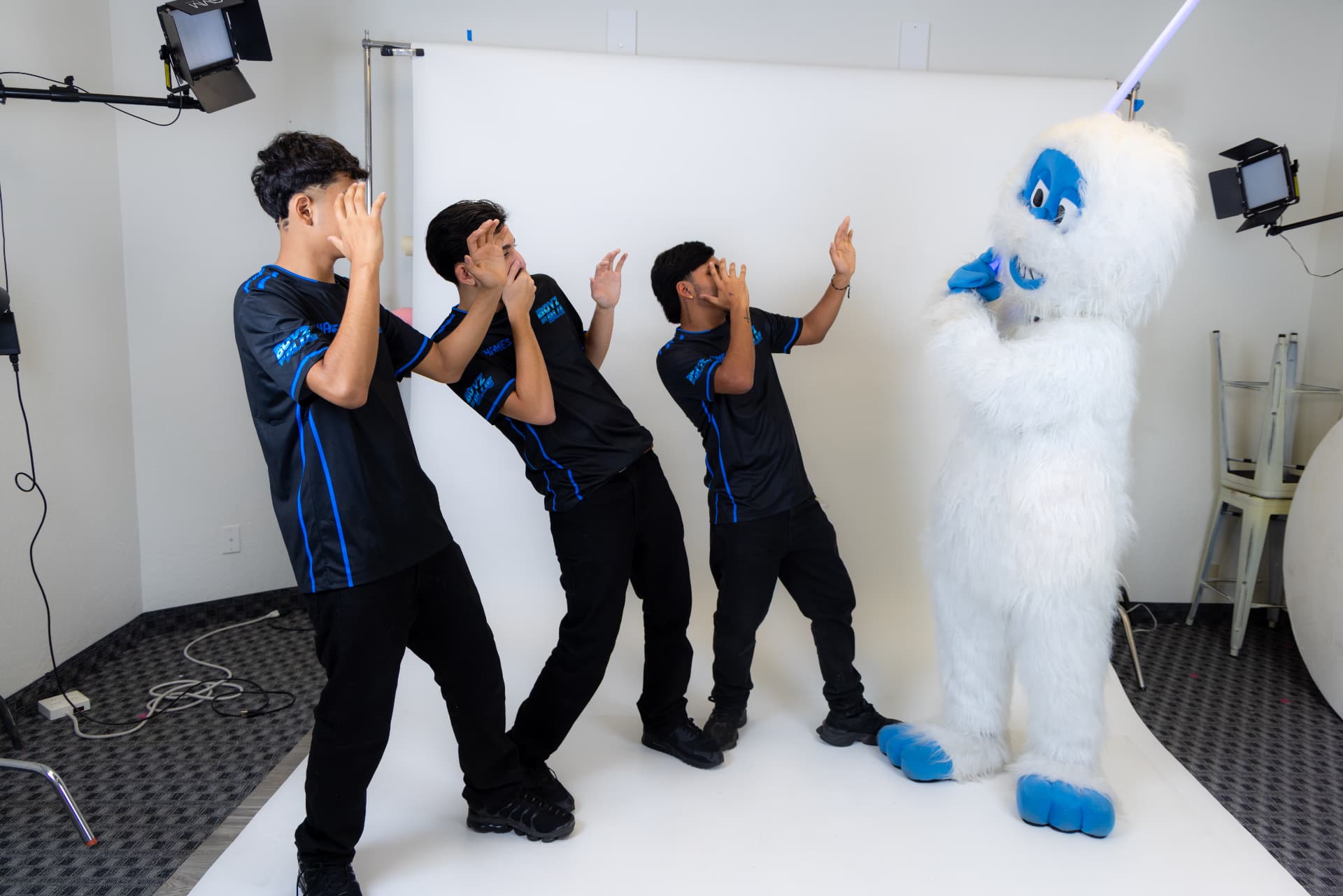 BOYZ IN BLUE crew reacting to the Yeti mascot in studio