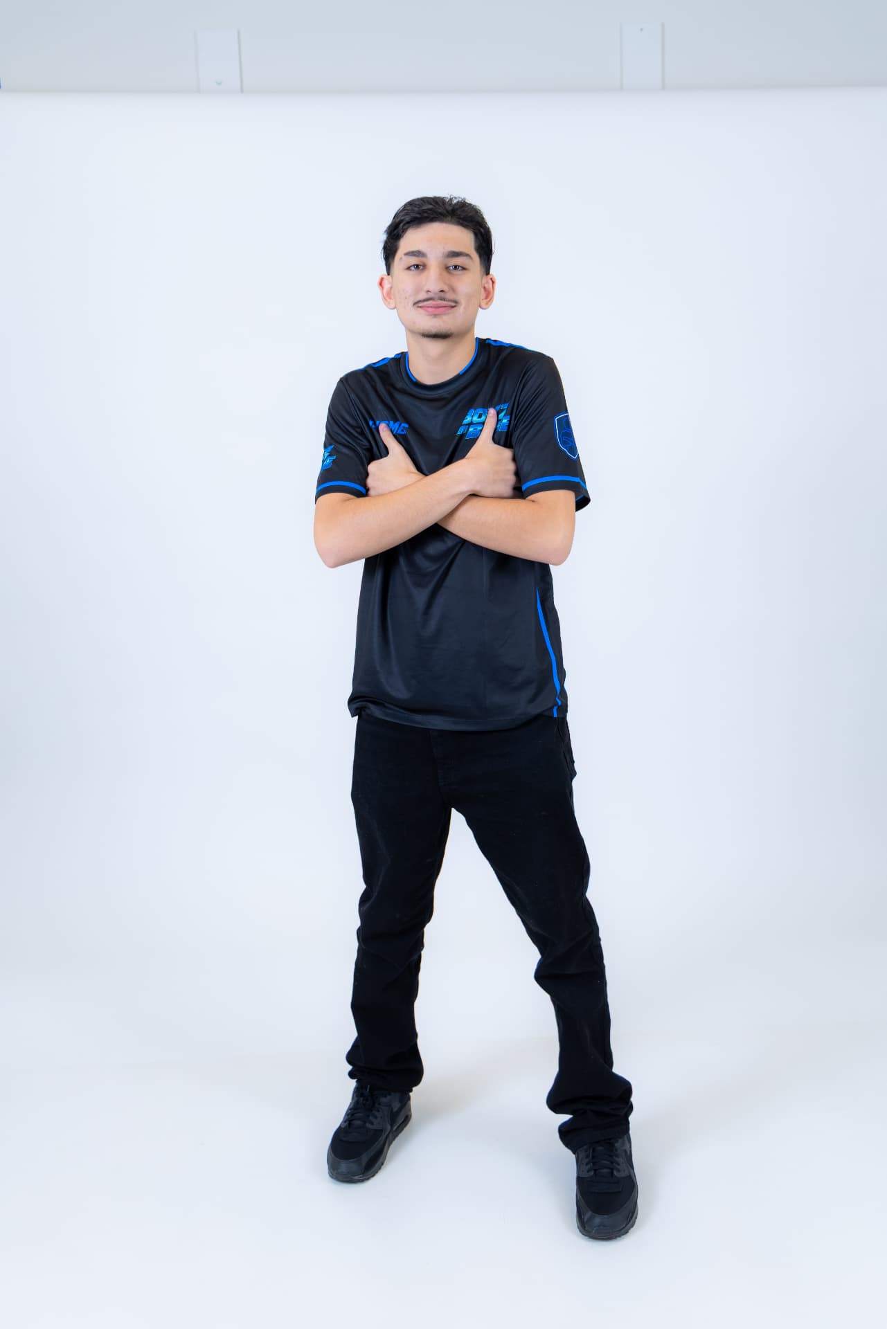 BOYZ IN BLUE performer crossing arms over the team crest